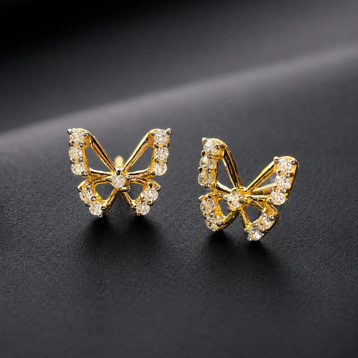 9K gold butterfly crystal earrings for girls with sparkling white stone detailing and polished gold finish by Marvel Silver.