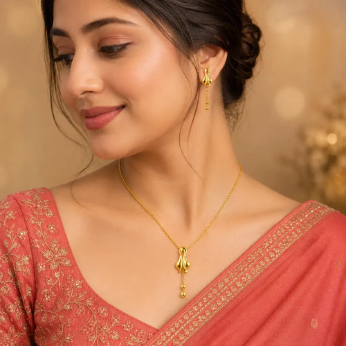 9K gold floral drop necklace set for women with polished pendant, hanging bead details and matching earrings by Marvel Silver.