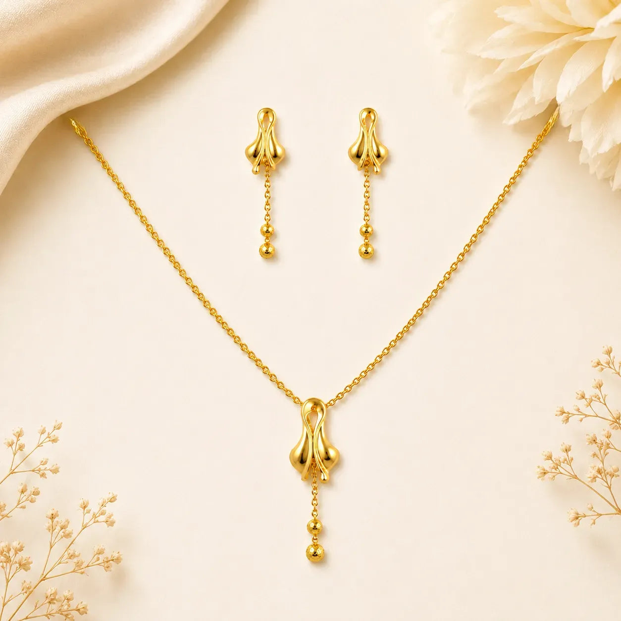 9K gold floral drop necklace set for women with polished pendant, hanging bead details and matching earrings by Marvel Silver.