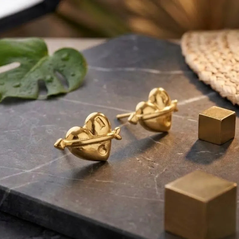 Marvel Silver 9K Gold heart and arrow stud earrings for girls featuring a polished love-inspired designer pattern with a premium gold finish.