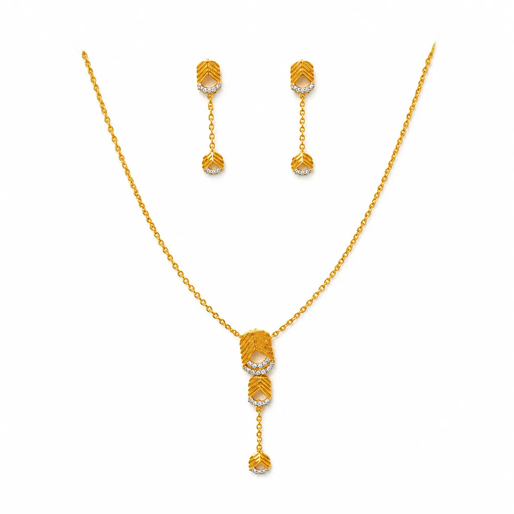 9K gold leaf drop necklace set for women with textured leaf pendant, stone detailing and matching hanging earrings by Marvel Silver.