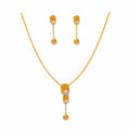 9K gold leaf drop necklace set for women with textured leaf pendant, stone detailing and matching hanging earrings by Marvel Silver.