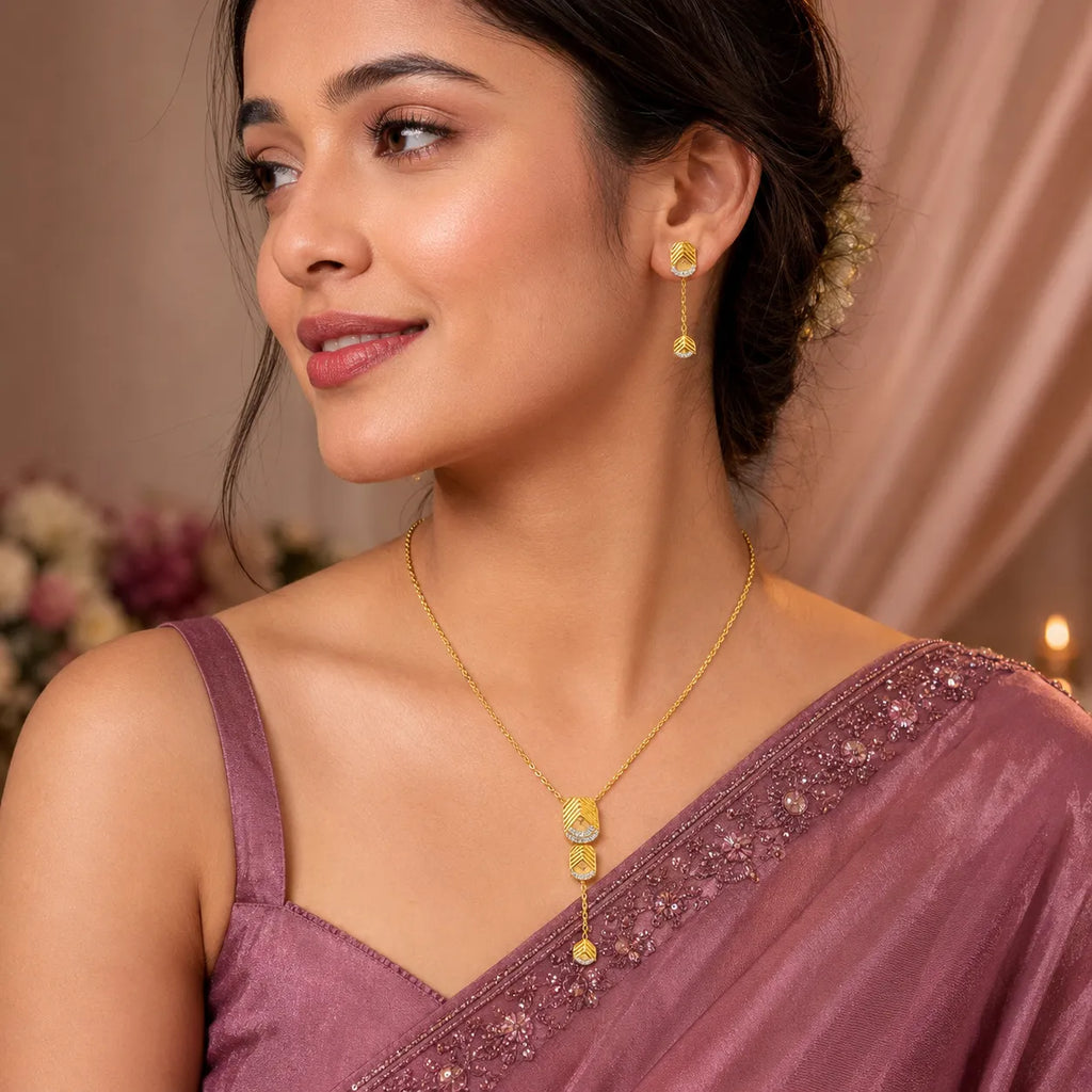 9K gold leaf drop necklace set for women with textured leaf pendant, stone detailing and matching hanging earrings by Marvel Silver.
