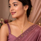 9K gold leaf drop necklace set for women with textured leaf pendant, stone detailing and matching hanging earrings by Marvel Silver.