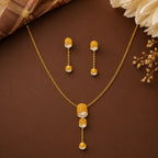 9K gold leaf drop necklace set for women with textured leaf pendant, stone detailing and matching hanging earrings by Marvel Silver.