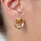 Marvel Silver 9K Gold modern circle knot stud earrings for girls featuring a polished gold circular frame with dual-tone gold and silver accents.