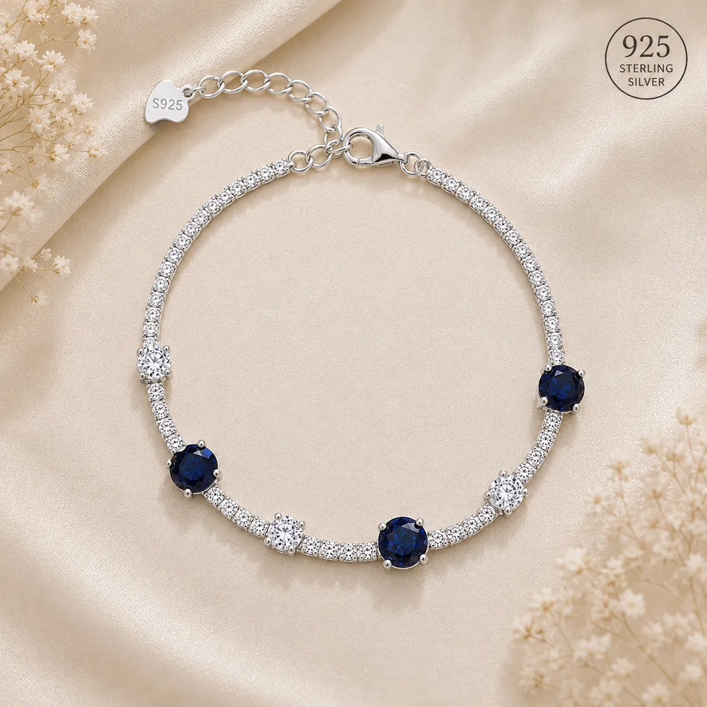 Marvel Silver 925 sterling silver tennis bracelet featuring sparkling blue sapphire-inspired Cubic Zirconia stones with brilliant white AAA Cubic Zirconia accents, rhodium-plated finish, adjustable extension chain, elegant bracelet for women and girls suitable for daily wear, parties, weddings, anniversaries, and gifting.