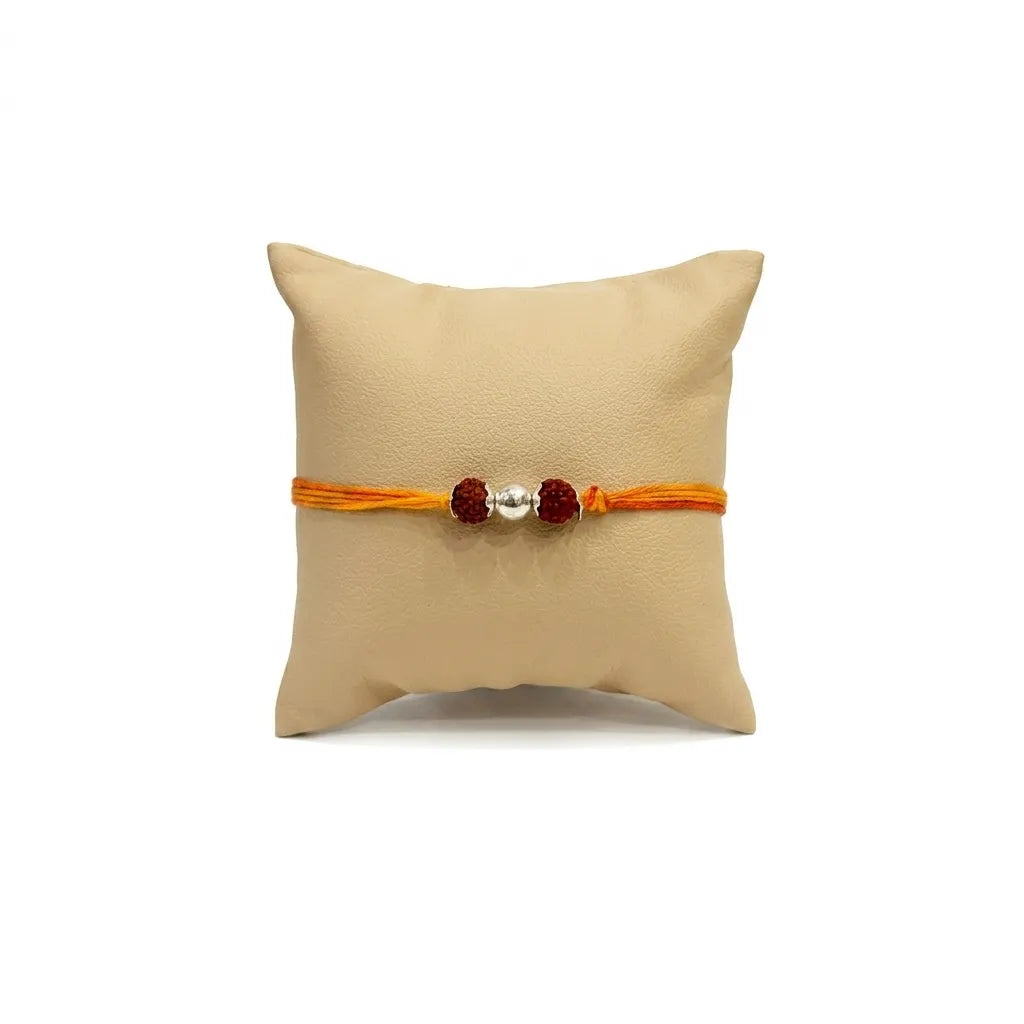 Marvel Silver Double Rudraksha Rakhi featuring two sacred Rudraksha beads, a premium silver center bead, and a saffron-orange thread for Raksha Bandhan celebrations.