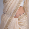 Marvel Silver Floral Charm Adjustable Silver Kamarbandh Worn by Woman with Cream and Gold Embroidered Saree Featuring Delicate Flower Charms and Polished Silver Beads