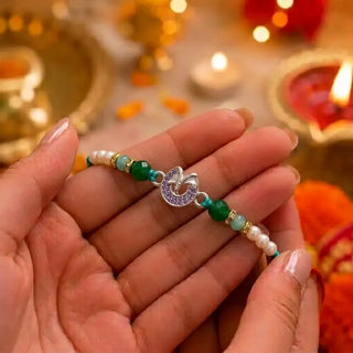 Ganesh Silver Rakhi with Green Crystal Beads