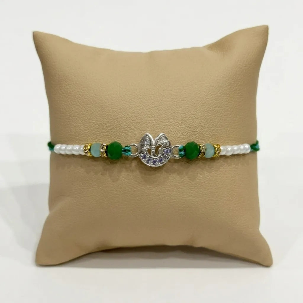 Marvel Silver Ganesh Silver Rakhi with Green Crystal Beads, White Pearl Beads and Sparkling Stones for Raksha Bandhan