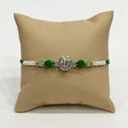 Marvel Silver Ganesh Silver Rakhi with Green Crystal Beads, White Pearl Beads and Sparkling Stones for Raksha Bandhan