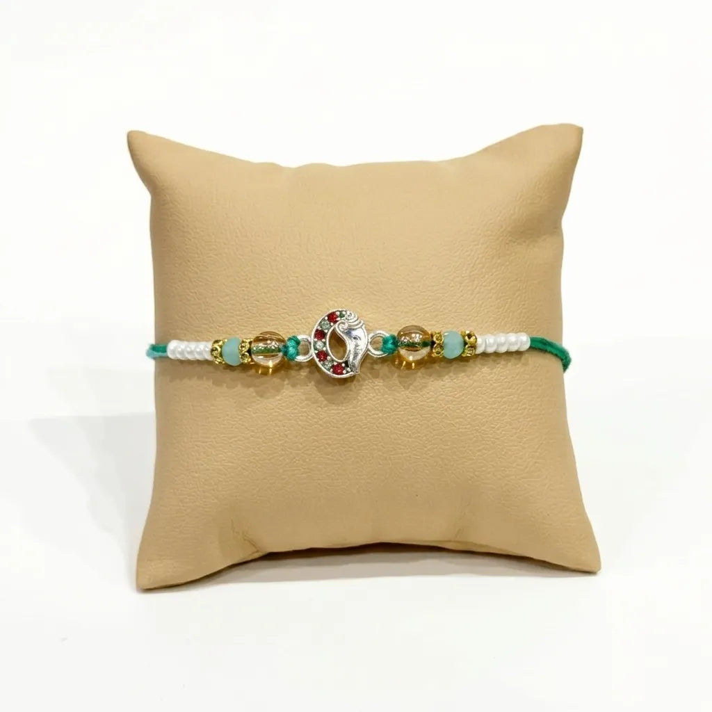 Marvel Silver Ganesh Silver Rakhi with Green Crystal Beads, White Pearl Beads, Golden Accent Beads and Red Green CZ Stones for Raksha Bandhan