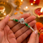 Marvel Silver Ganesha Silver Rakhi with Green Crystal Beads and White Pearl Beads for Raksha Bandhan