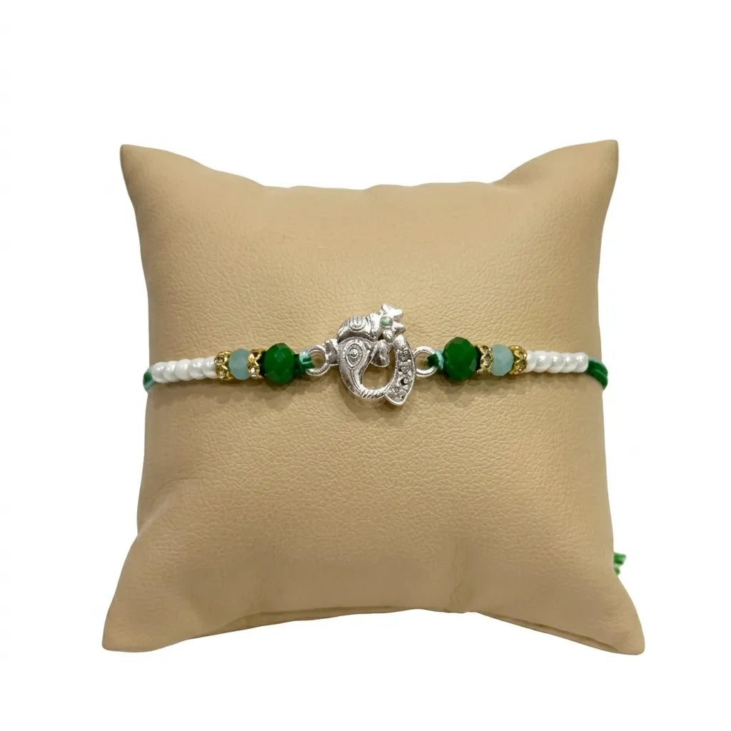 Marvel Silver Ganesha Silver Rakhi with Green Crystal Beads and White Pearl Beads for Raksha Bandhan