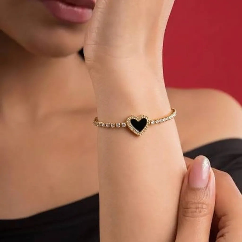 Marvel Silver gold-plated tennis bracelet featuring sparkling crystal stones, a black heart centerpiece with crystal detailing, and a secure box clasp, designed for women and girls for parties, weddings, festive occasions, daily wear, and gifting.