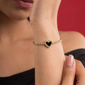 Marvel Silver gold-plated tennis bracelet featuring sparkling crystal stones, a black heart centerpiece with crystal detailing, and a secure box clasp, designed for women and girls for parties, weddings, festive occasions, daily wear, and gifting.