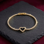 Marvel Silver gold-plated tennis bracelet featuring sparkling crystal stones, a black heart centerpiece with crystal detailing, and a secure box clasp, designed for women and girls for parties, weddings, festive occasions, daily wear, and gifting.