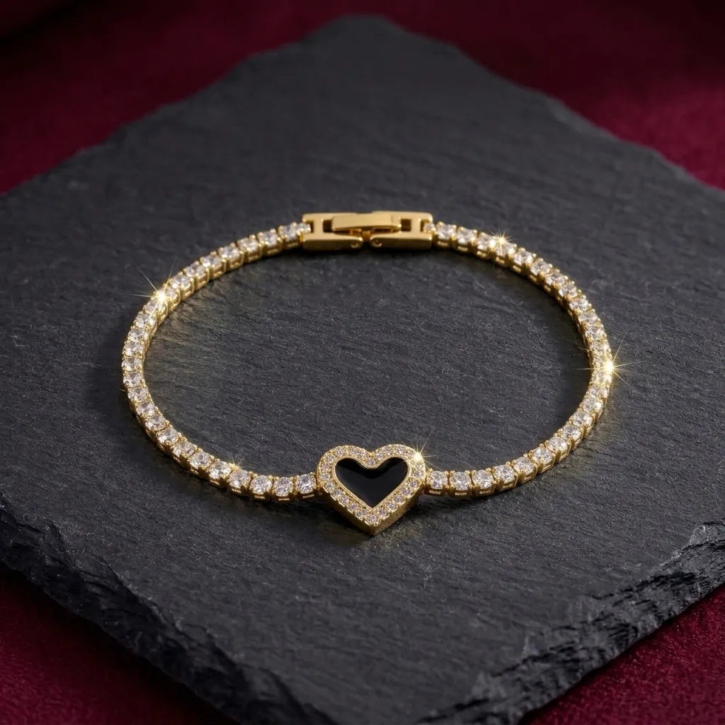 Marvel Silver gold-plated tennis bracelet featuring sparkling crystal stones, a black heart centerpiece with crystal detailing, and a secure box clasp, designed for women and girls for parties, weddings, festive occasions, daily wear, and gifting.