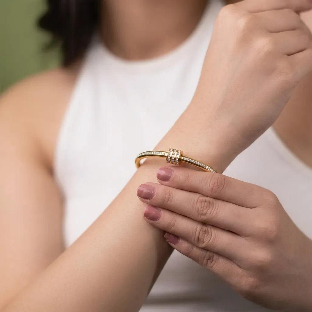 Marvel Silver gold-plated slim bangle kada featuring sparkling Cubic Zirconia stone detailing and an elegant triple-ring centerpiece with a secure hinged clasp, designed for women and girls, perfect for weddings, parties, office wear, festive occasions, daily wear, and gifting.