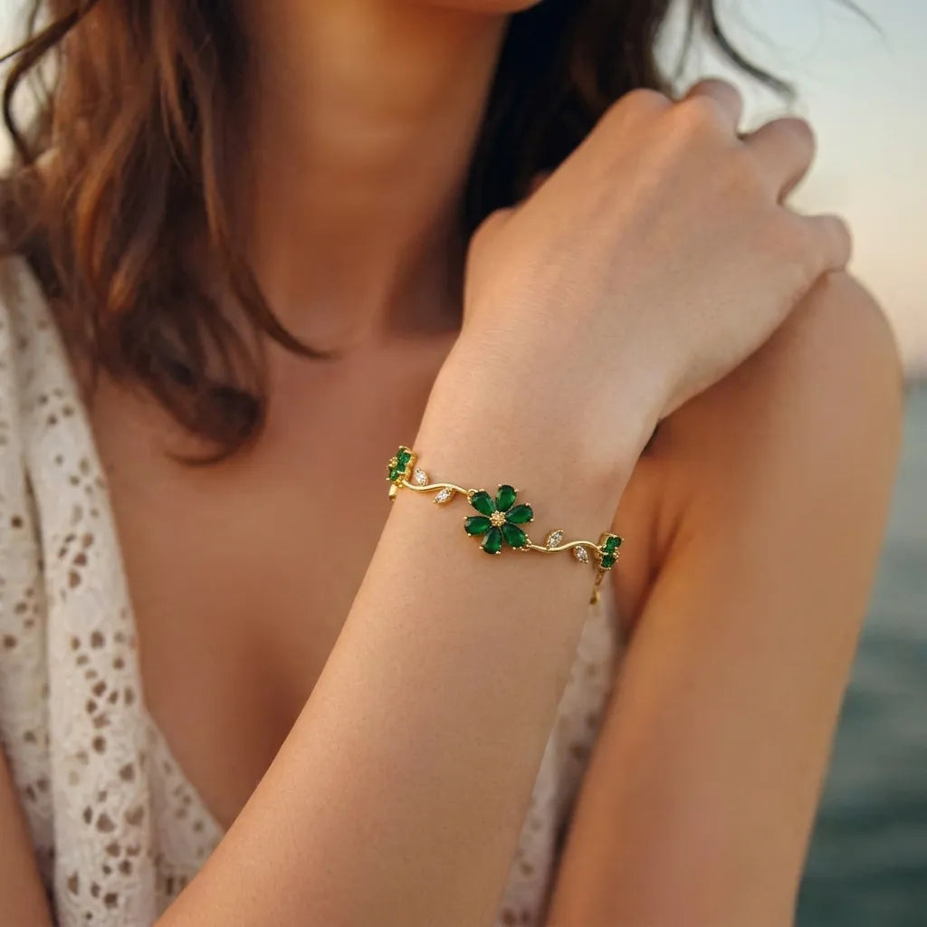 Marvel Silver gold-plated bracelet featuring emerald green floral stones, sparkling crystal leaf accents, vine-inspired detailing, and an adjustable extension chain for women and girls, perfect for daily wear, parties, weddings, festive occasions, and gifting.