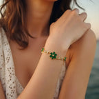 Marvel Silver gold-plated bracelet featuring emerald green floral stones, sparkling crystal leaf accents, vine-inspired detailing, and an adjustable extension chain for women and girls, perfect for daily wear, parties, weddings, festive occasions, and gifting.