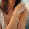 Marvel Silver gold-plated bracelet featuring delicate pink floral charms, green leaf accents, gold bead detailing, and an adjustable chain for women and girls, ideal for everyday wear, parties, weddings, festive occasions, and gifting.