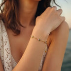 Marvel Silver gold-plated bracelet featuring delicate pink floral charms, green leaf accents, gold bead detailing, and an adjustable chain for women and girls, ideal for everyday wear, parties, weddings, festive occasions, and gifting.