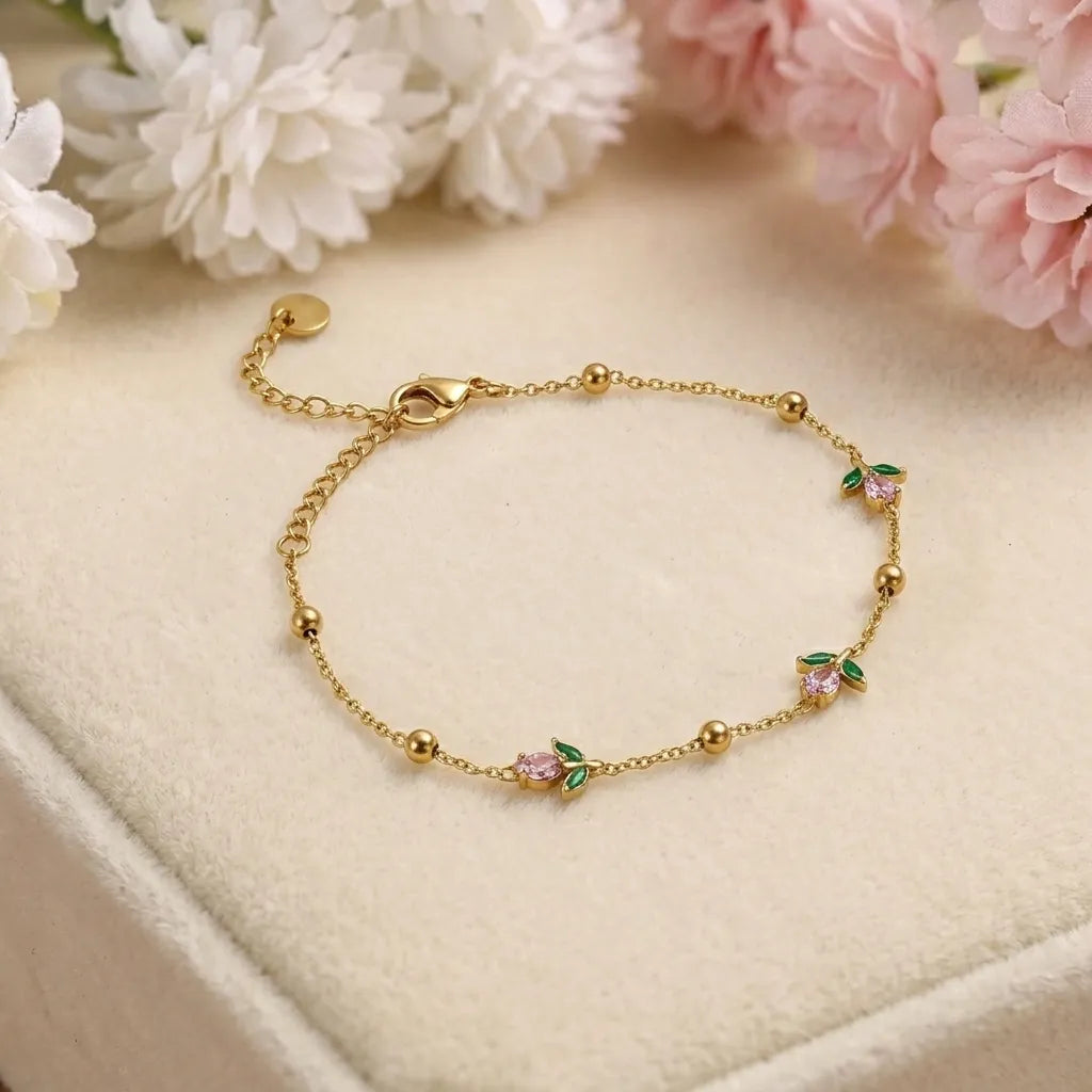 Marvel Silver gold-plated bracelet featuring delicate pink floral charms, green leaf accents, gold bead detailing, and an adjustable chain for women and girls, ideal for everyday wear, parties, weddings, festive occasions, and gifting.