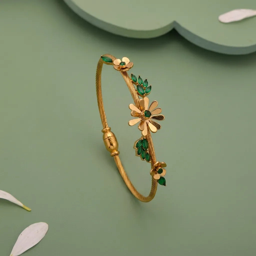 Marvel Silver gold-plated floral leaf designer kada featuring elegant flower motifs, green enamel leaves, and a premium twisted wire band with a secure magnetic clasp, perfect for women and girls for weddings, parties, festive occasions, daily wear, and gifting.