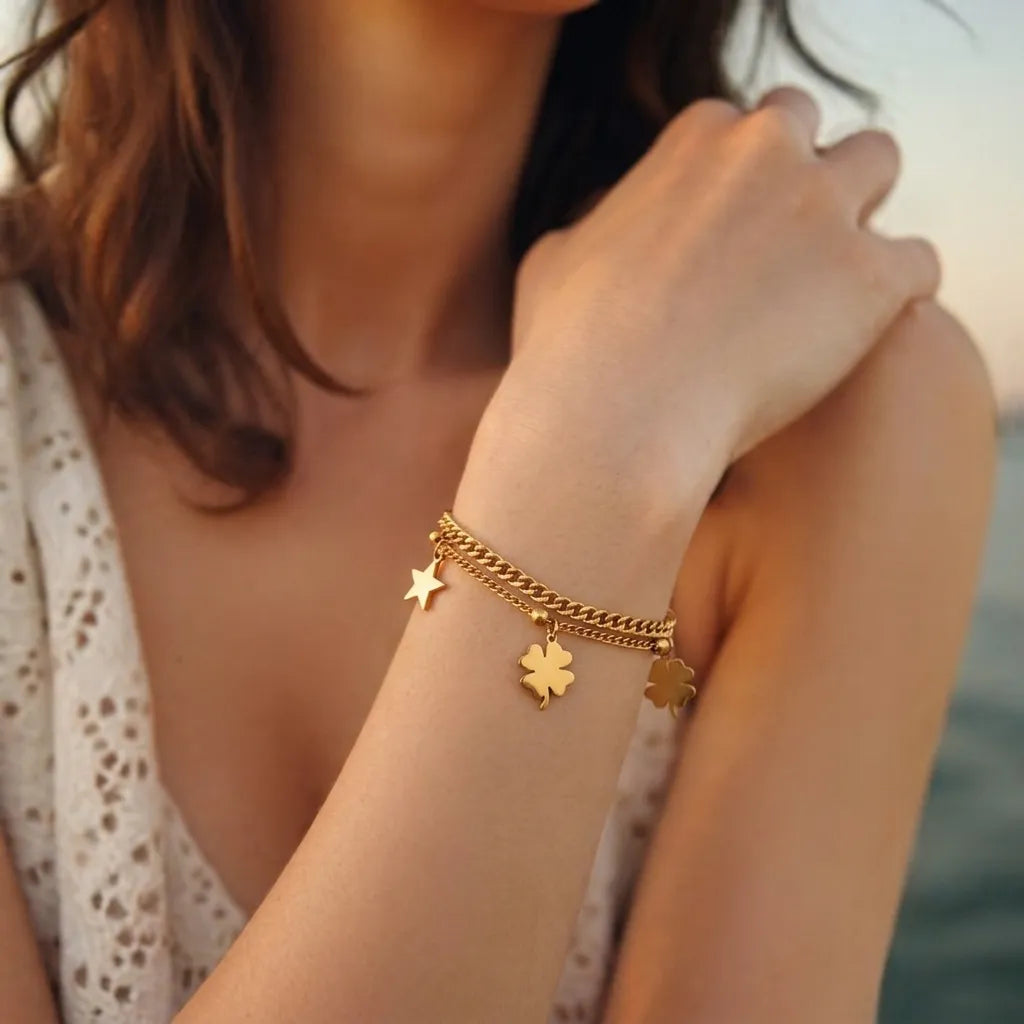 Marvel Silver gold-plated layered bracelet featuring elegant four-leaf clover charms, a star charm, dual-chain design, and an adjustable extension chain, perfect for women and girls for daily wear, parties, festive occasions, and gifting.