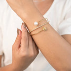 Marvel Silver gold-plated open cuff kada featuring sparkling cubic zirconia detailing, a premium pearl accent, and an elegant floral charm, designed for women and girls, perfect for weddings, parties, festive occasions, daily wear, and gifting.