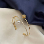 Marvel Silver gold-plated open cuff kada featuring sparkling cubic zirconia detailing, a premium pearl accent, and an elegant floral charm, designed for women and girls, perfect for weddings, parties, festive occasions, daily wear, and gifting.