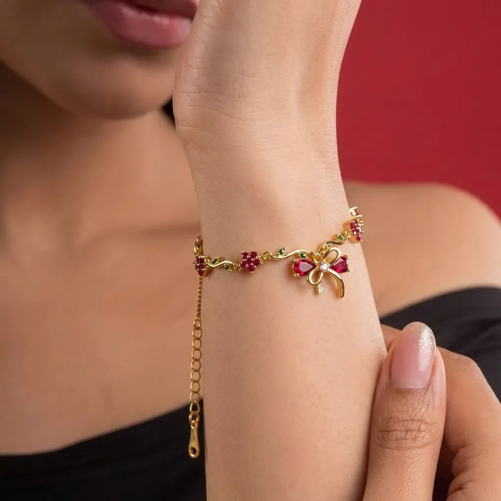 Marvel Silver gold-plated bracelet featuring a ruby-red butterfly centerpiece, floral stone charms, green leaf accents, and an adjustable extension chain for women and girls, ideal for daily wear, parties, weddings, festive occasions, and gifting.