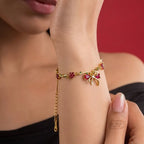 Marvel Silver gold-plated bracelet featuring a ruby-red butterfly centerpiece, floral stone charms, green leaf accents, and an adjustable extension chain for women and girls, ideal for daily wear, parties, weddings, festive occasions, and gifting.