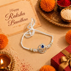 Marvel Silver Krishna Flute Silver Rakhi with Blue CZ Stone, White Crystal Beads and White Pearl Beads for Raksha Bandhan
