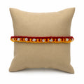 Marvel Silver yellow red rakhi with mixed floral and geometric silver-tone decorative motifs