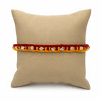 Marvel Silver yellow red rakhi with mixed floral and geometric silver-tone decorative motifs