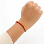 Marvel Silver yellow red rakhi with mixed floral and geometric silver-tone decorative motifs