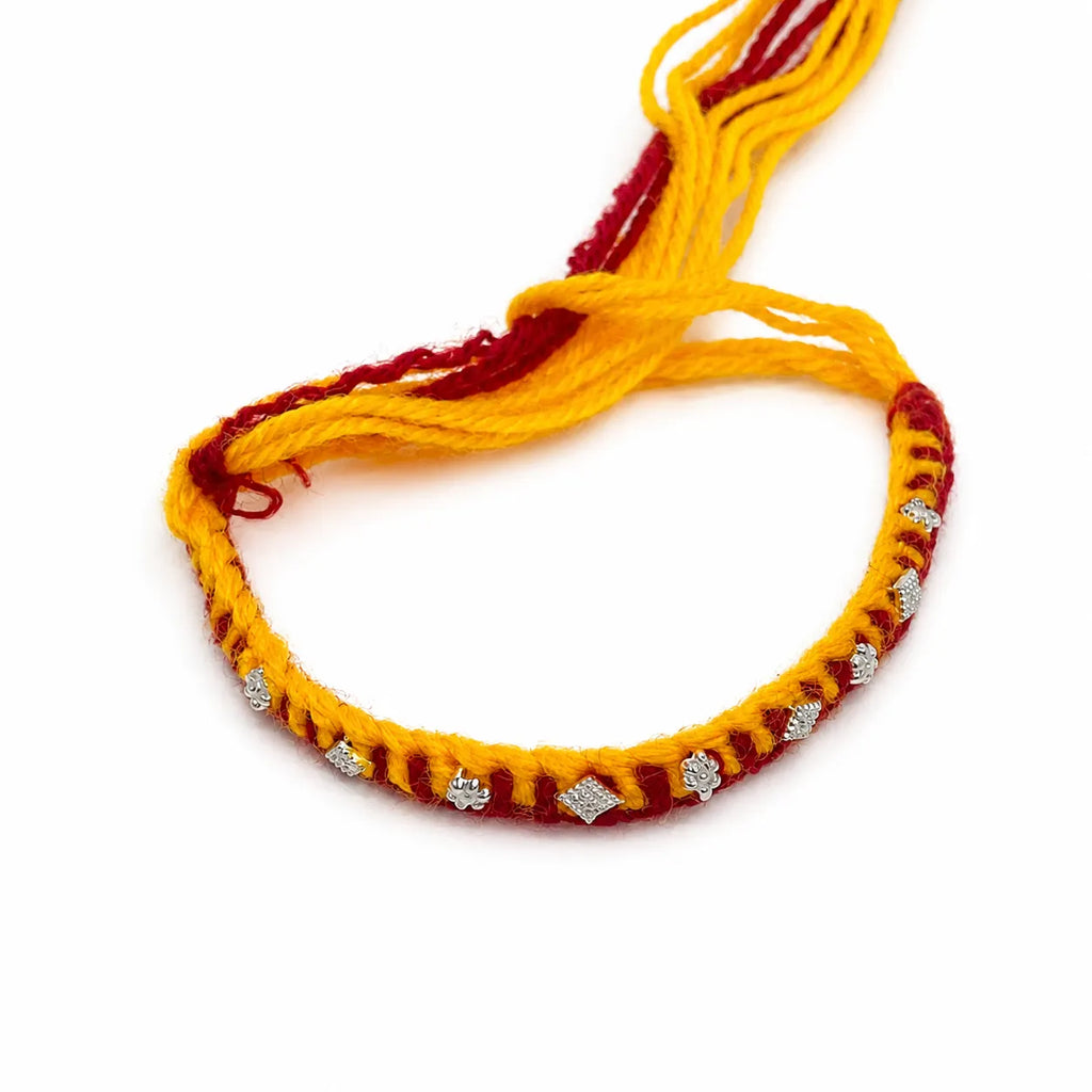 Marvel Silver yellow red rakhi with mixed floral and geometric silver-tone decorative motifs