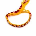 Marvel Silver yellow red rakhi with mixed floral and geometric silver-tone decorative motifs