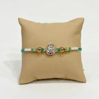 Marvel Silver Om Damru Silver Rakhi with Green Crystal Beads, White Pearl Beads and Silver Om Damru Symbol for Raksha Bandhan