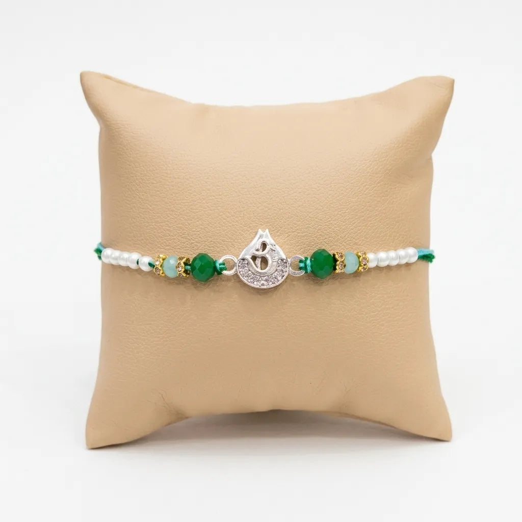 Marvel Silver Om Silver Rakhi with Green Crystal Beads, White Pearl Beads and Sparkling Om Symbol for Raksha Bandhan