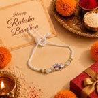 Marvel Silver Peacock Feather Silver Rakhi with Purple CZ Stones, White Crystal Beads and White Pearl Beads for Raksha Bandhan