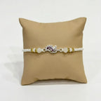 Marvel Silver Peacock Feather Silver Rakhi with Purple CZ Stones, White Crystal Beads and White Pearl Beads for Raksha Bandhan
