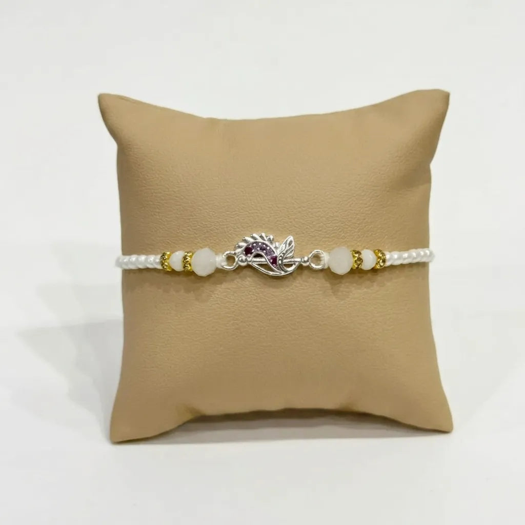 Marvel Silver Peacock Feather Silver Rakhi with Purple CZ Stones, White Crystal Beads and White Pearl Beads for Raksha Bandhan