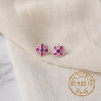 Marvel Silver pink daisy flower stud earrings featuring silver-plated finish, pink enamel petals, and a purple center, perfect for women and girls.