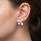 Marvel Silver pink and white floral enamel imitation stud earrings with CZ stones and gold-tone finish for women.