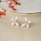 Marvel Silver pink and white floral enamel imitation stud earrings with CZ stones and gold-tone finish for women.