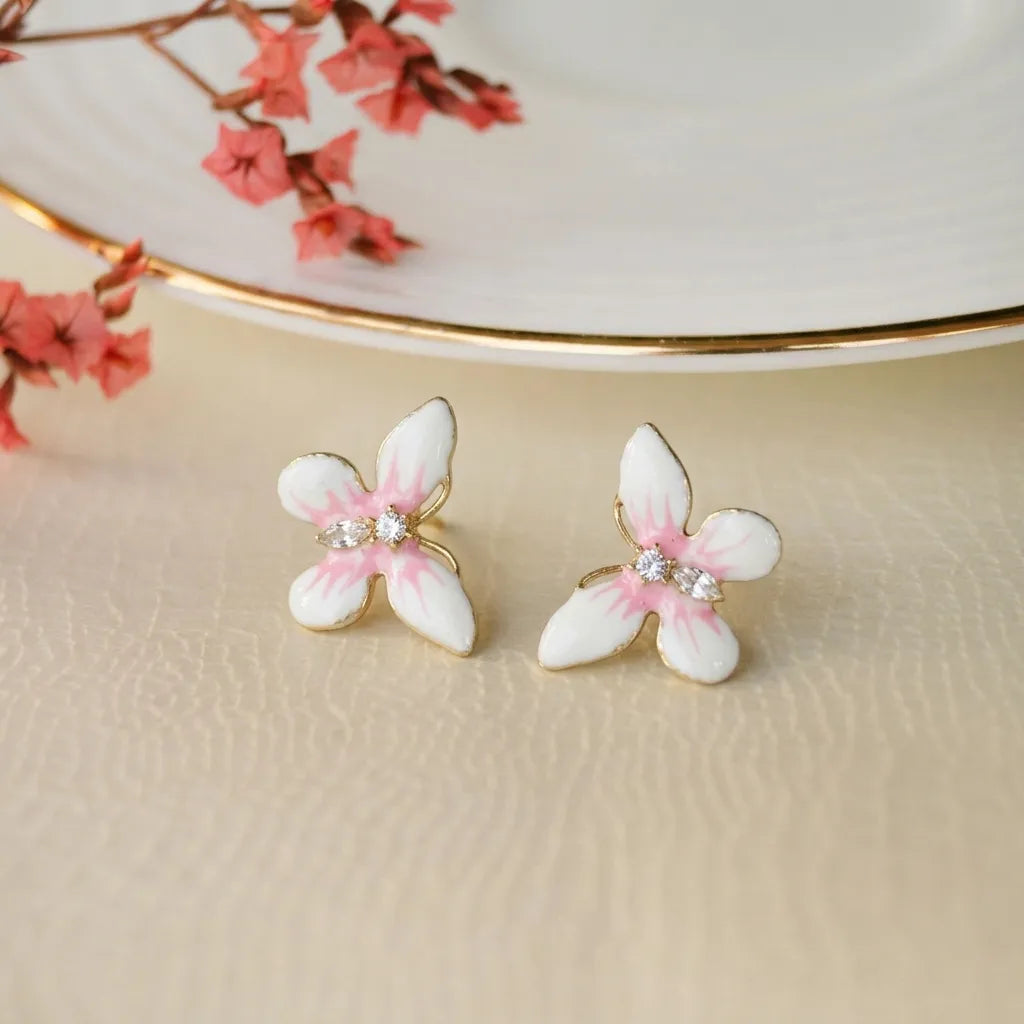 Marvel Silver pink and white floral enamel imitation stud earrings with CZ stones and gold-tone finish for women.